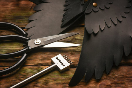 Leather craft work tools and leather on the tanner workbench concept background.