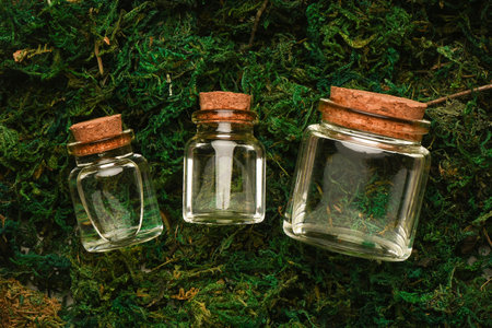 Spring water in the jar on the natural moss background.の写真素材