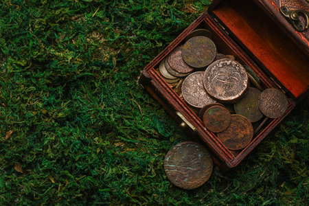 Treasure chest with old coins on the pirate table concept background.の写真素材