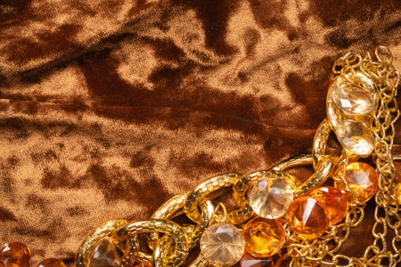 Golden jewels and gem stones on the table close up. Treasure concept.の写真素材