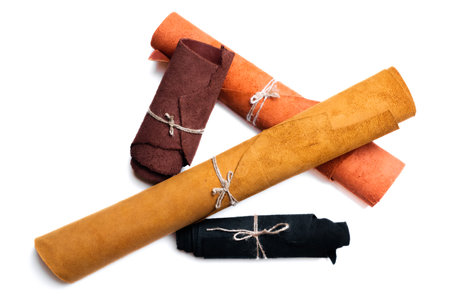 Leather rolled up pieces isolated on white background. Top view.