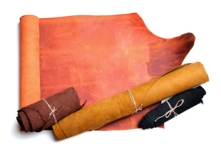 Leather rolled up pieces isolated on white background. Top view.