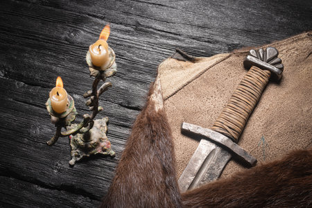 Ancient sword wrapped in the beast skin on the table close up.の写真素材