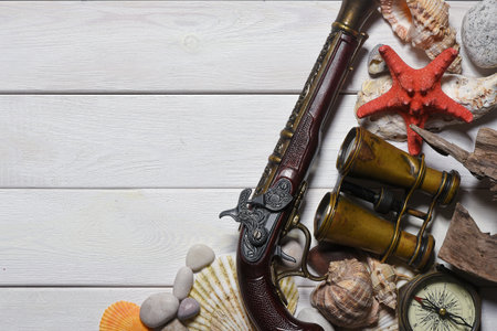 Sea travel or piracy concept background. Sea ship boat, compass and compass on the wooden desk table background.の写真素材