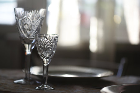 Crystal glasses on the festive table background.