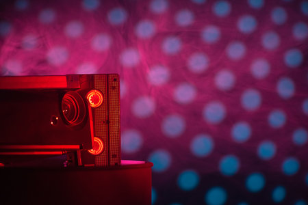 Multimedia projector and old vhs cassette on the colorful background with copy space. Front view.の写真素材