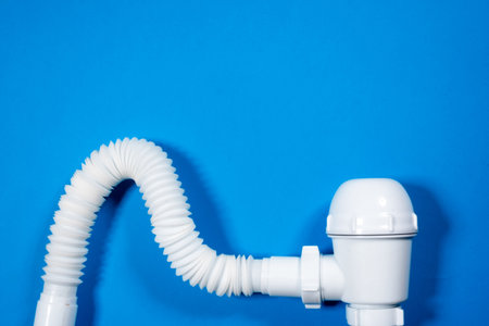 Bathtub drain pipeline system parts on the blue top view background copy space. Siphon flat lay.の写真素材