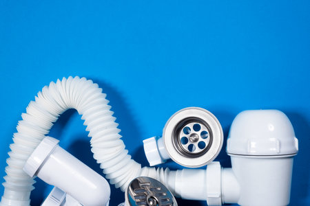 Bathtub drain pipeline system parts on the blue top view background copy space. Siphon flat lay.の写真素材