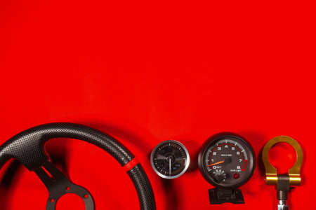 Sport car tuning equipment and spare parts on red top view background with copy space. Motorsport...