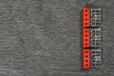 Wiring connectors on the gray workbench flat lay background with copy space. Electrical works.