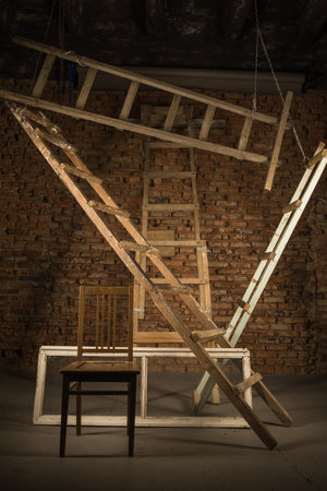 Old wooden step ladders on the construction site background. Building house abstract background.