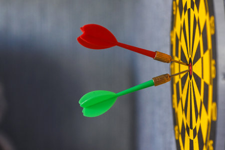 Spears in dart board game close up background.の写真素材