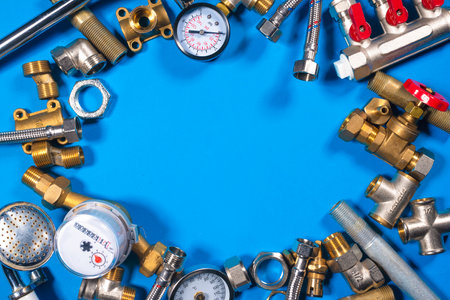 Plumbing water line equipment on the blue flat lay background. Plumbing service with copy space.