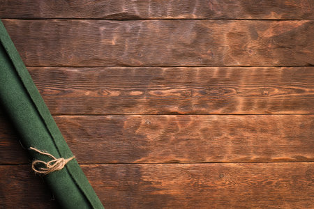 Green leather rolled up pieces scrolls on the brown flat lay table background. Top view.の写真素材
