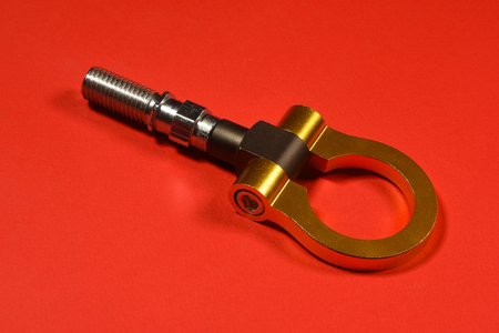Sport car tow hook on the red flat lay background close up with copy space.の写真素材