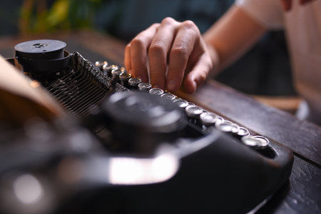 Man typing text on an old typewriter close up.の写真素材