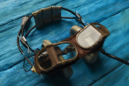 Retro style pilot goggles and headset on the blue sky concet background.の写真素材