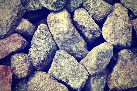 Dirty stones lying on the road shot from above