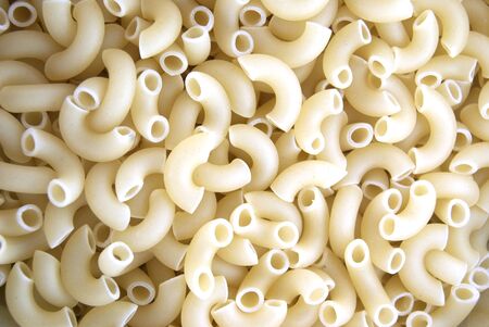 Dried curved pasta as a backgroundの写真素材