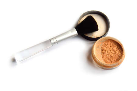 Beige powder and a brush on the white backgroundの写真素材