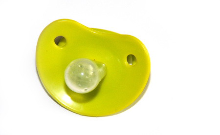 A rubber soother  with holes isolated on white の写真素材