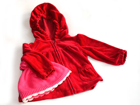 A red velvet coat for a kid with a rose hat on whiteの写真素材