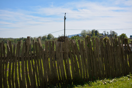 Old wooden fence in the country in the bright summer dayの写真素材