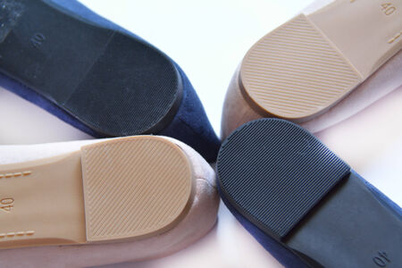 Two pairs of woman shoes upright over whiteの写真素材