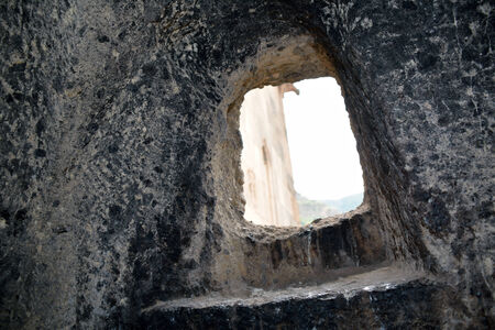 The window in the church of the Geghard monastery, Armenia, with the viewの写真素材