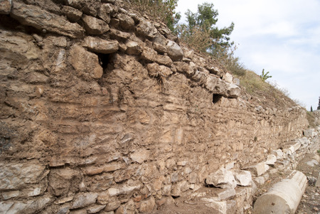 The earth wall ready for excavation and the piece of the column in Ephesus, Turkeyの写真素材