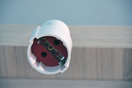 A socket hanging from the furniture closeup