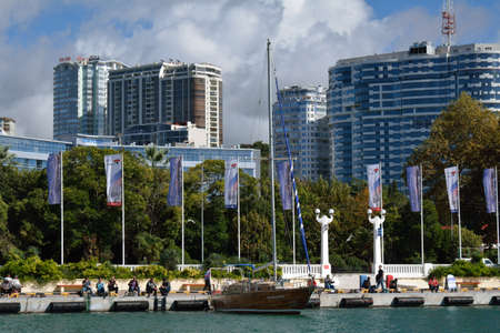 Sea port in Sochi, Russia, with boats, fishers and high buildings in the farのeditorial素材