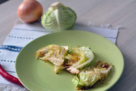 slices of baked cabbage with hot pepper on the plateの写真素材