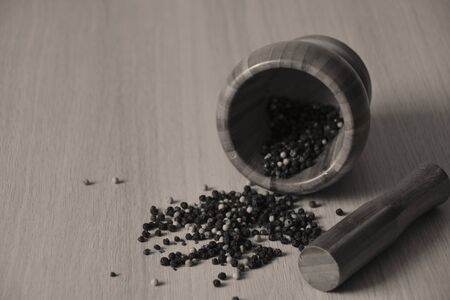 wooden mortar with pepper, sepia tonedの写真素材