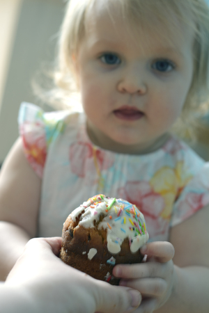 cute little girl takes small easter breadの写真素材