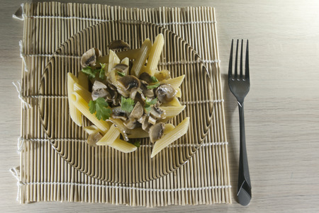 Penne rigato with mushrooms on the plateの写真素材