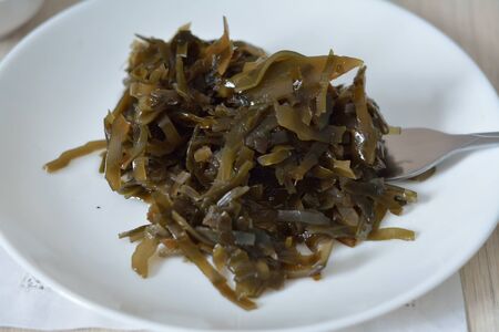 soft laminaria snack with a forkの写真素材