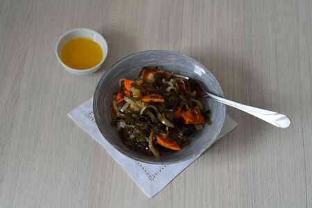 vegetable salad with laminaria and oily dressing in a bowlの写真素材