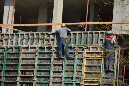 PODOLSK, 28.04.2015 workers making staging on the building