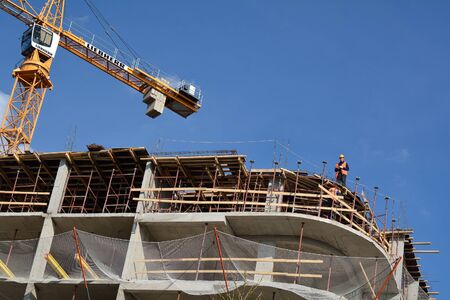 PODOLSK, 28.04.2015 - worker making preparations on the edge of the construction building