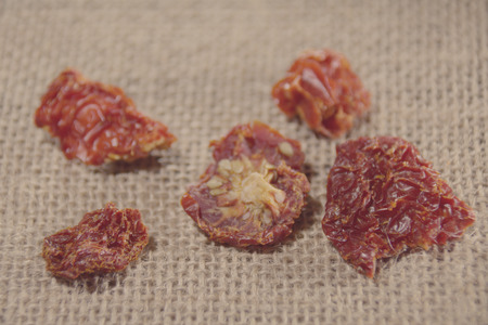 Dried tomatoes in pieces on the clothの写真素材
