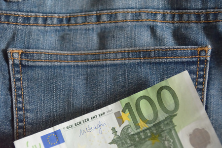 Detail of a hundred euro note over the jean fabricの写真素材