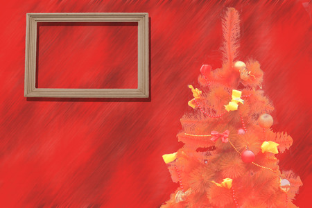 decorated fir tree with a wooden picture frame on redの写真素材