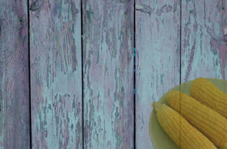 Plate of corn on old  wooden backgroundの写真素材