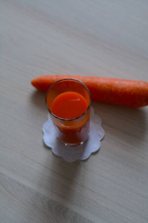 sweet carrot juice with a fresh vegetable on the wooden tableの写真素材