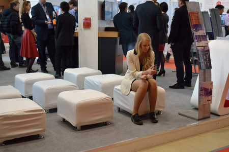 MOSCOW/RUSSIAN FEDERATION - APRIL 15 2015: girl sitting and waiting at the exhibitionのeditorial素材