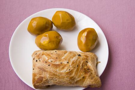 plate with boiled eggs and a samsa on the table