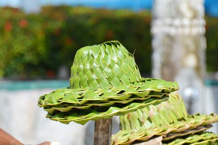 Several straw hats in a heap, on the stick, for saleの写真素材