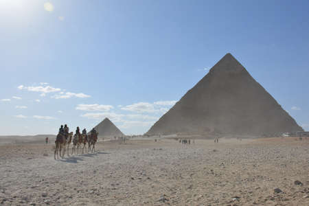 GIZA/EGYPT, NOVEMBER 30, 2018: desert next to the pyramids, with the tourists and camels, on cloudy weatherのeditorial素材
