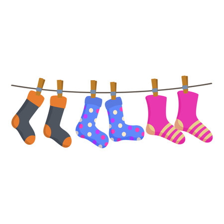 Colorful socks hanging on clothesline after laundryのイラスト素材